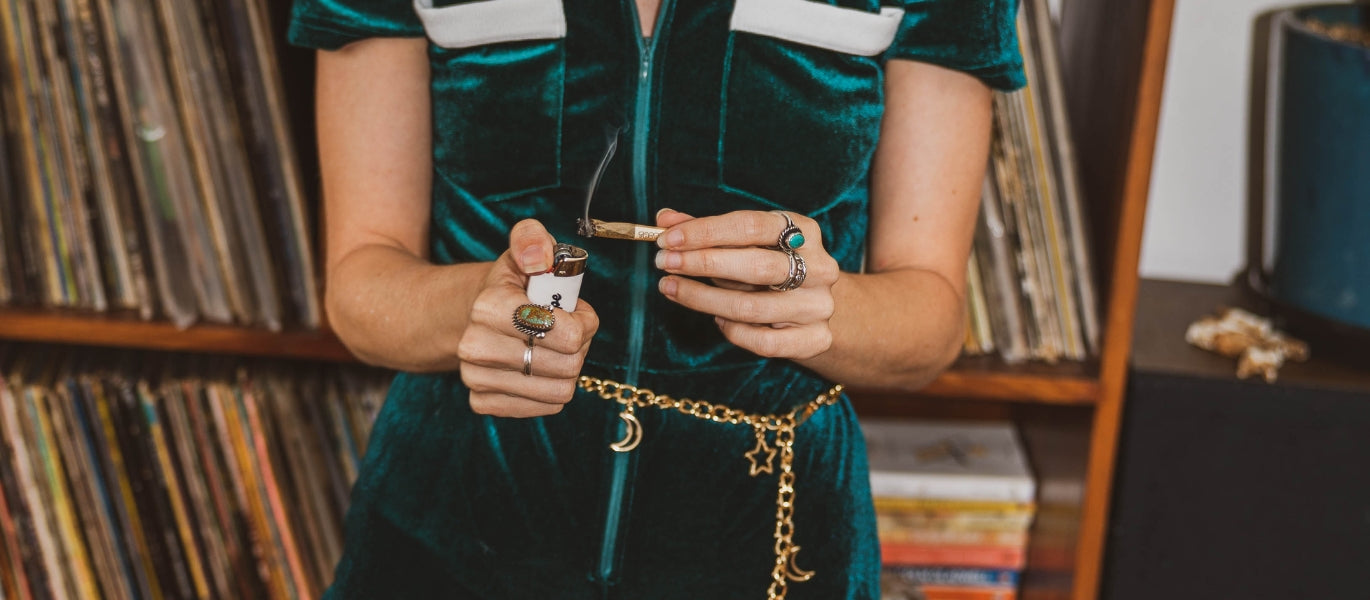 Woman lighting pre-rolled cone