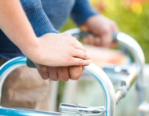 man holding walking frame