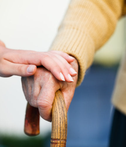 man holding walking stick