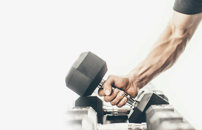 a man's hand lifting DMoose hex dumbbell