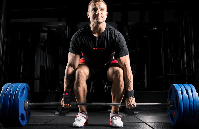 A strong man going to do deadlift while wearing DMoose crossfit grips on his hands