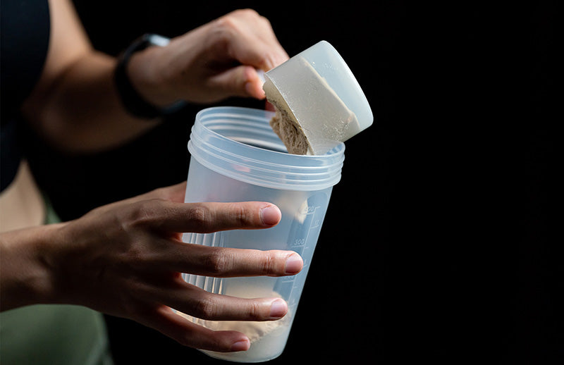 A man putting his protein paste in Dmoose shaker