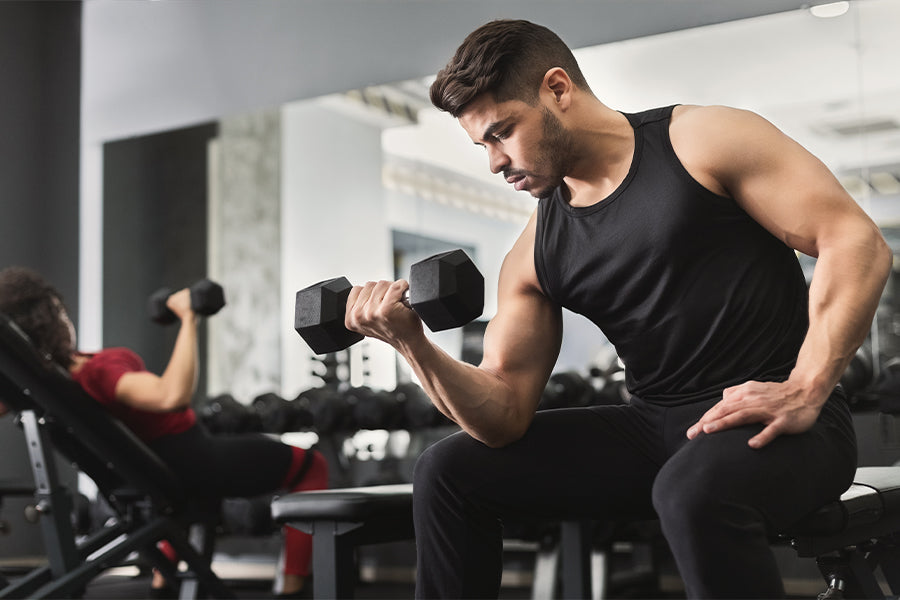 A man doing bicep workout using Dmoose dumbbells