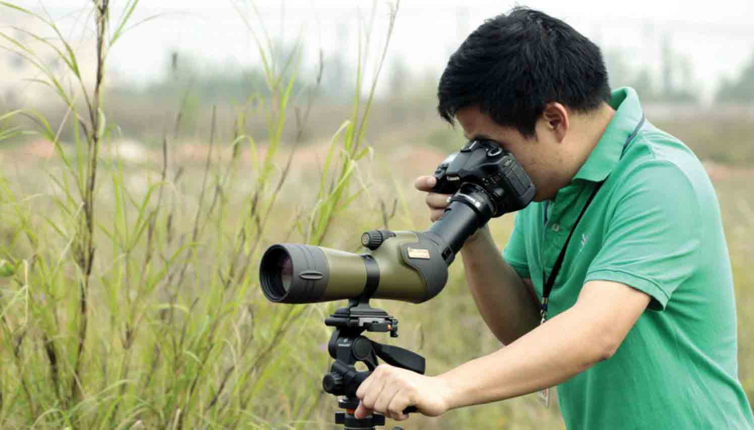 Man using Vanguard spotting scopes