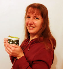 Picture of Sarah holding a mug of lovely hot Shiloh coffee and smiling