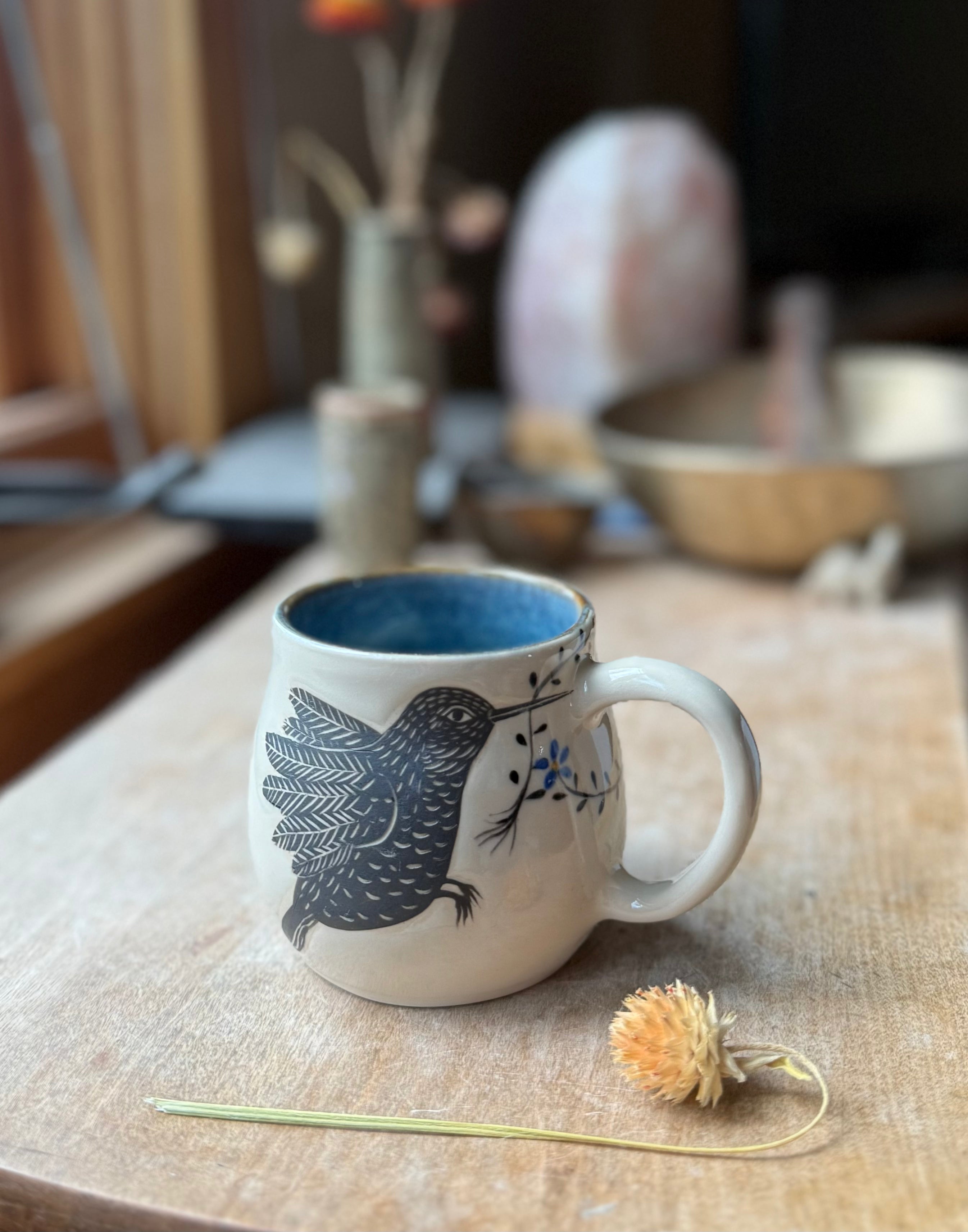 Hummingbird with forget me not mug
