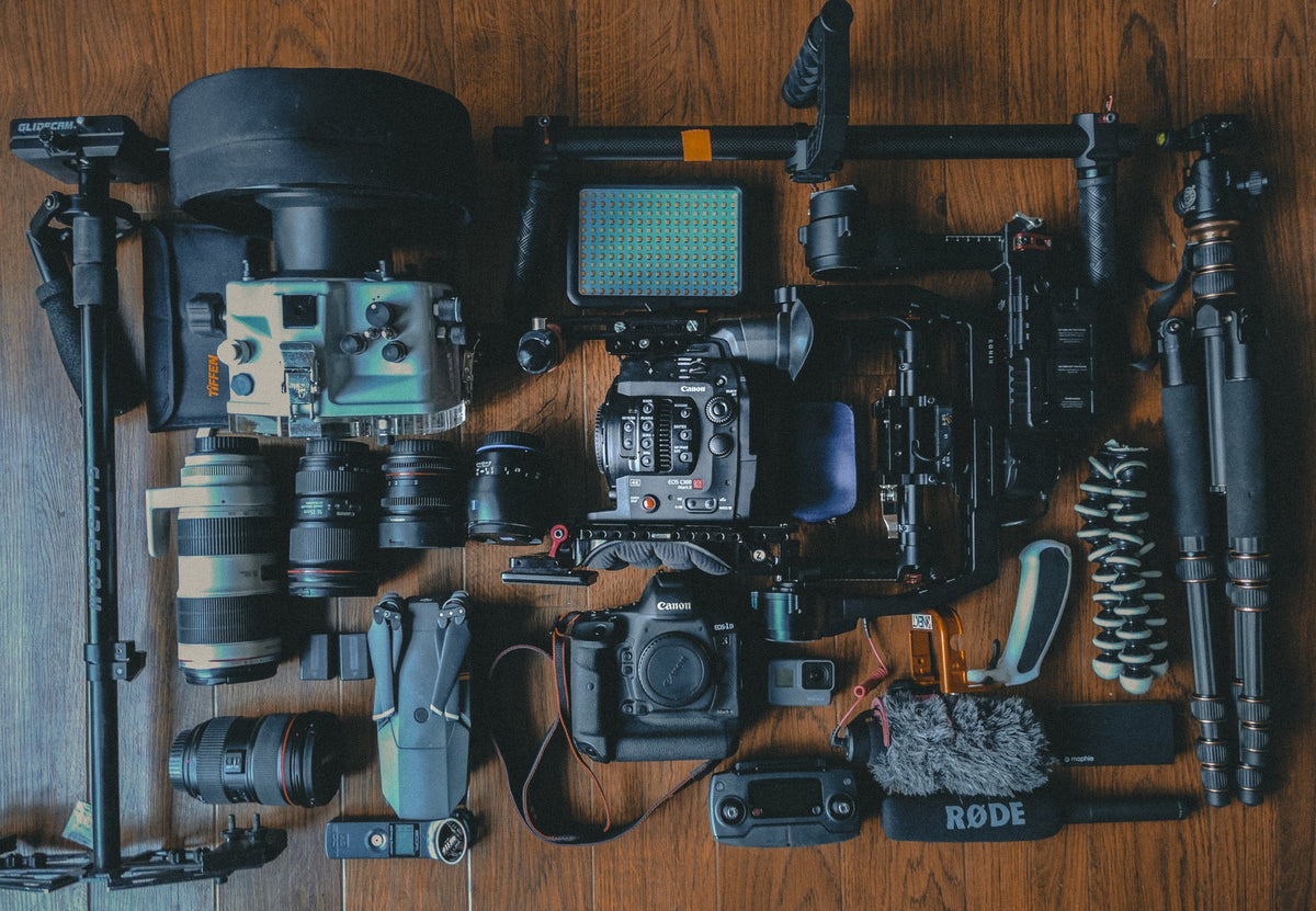 An assemblance of a professional camera and all the gear and supplies that go with it