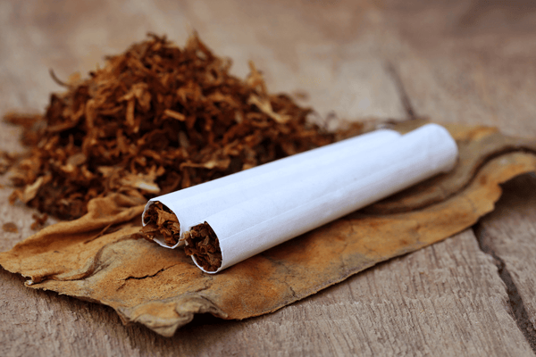 Tobacco and a rolled cigarette on a table