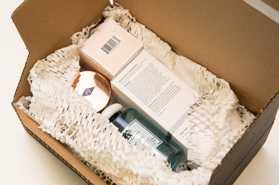 A package with luxury beauty items being protected by paper void fill.