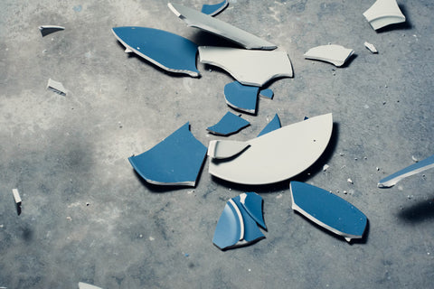 A close up image of a plate that has been smashed into small pieces.