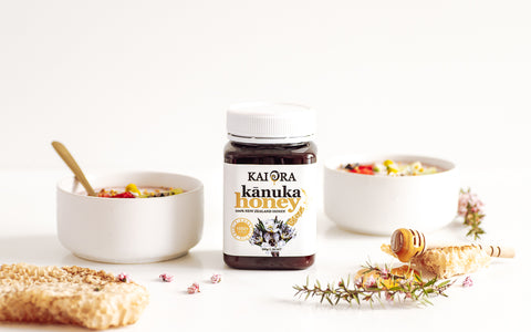Pouring Kai Ora Kanuka Honey into smoothie mix