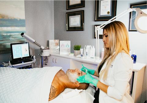 Man laying down and receiving facial procedure