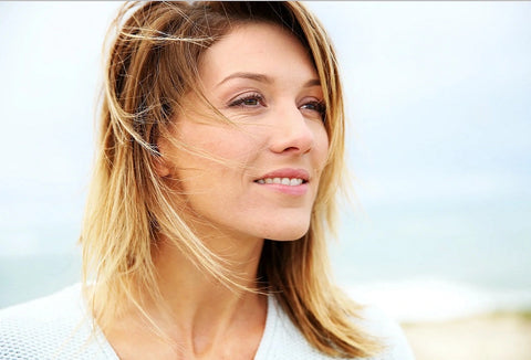 Blonde woman standing on beach