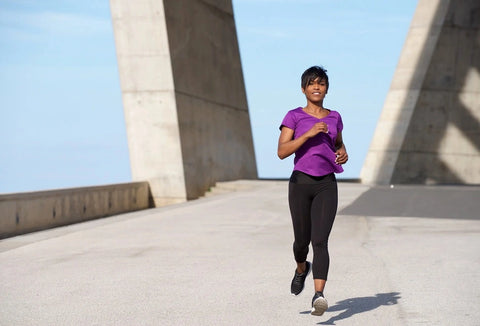 An older African American woman running outside