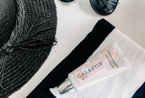 ALASTIN Skincare's tinted sunscreen on top of black and white cloth