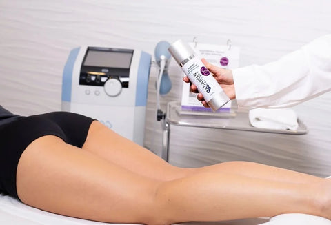 Woman's legs and bottle of TransFORM Body Treatment with TriHex Technology above them®