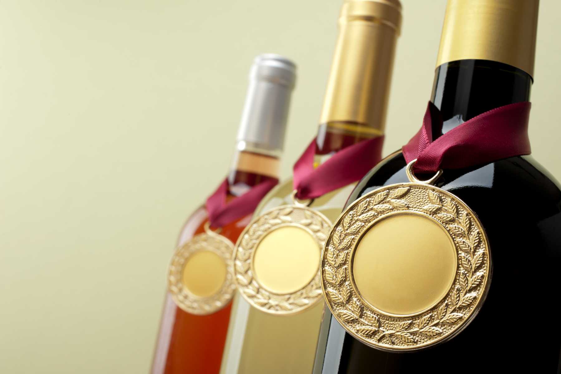 different kinds of wine bottles with wine medals