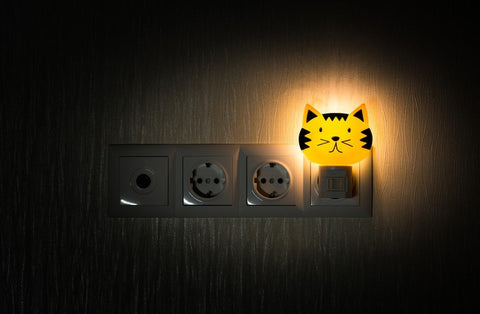 A kids night light that looks like the face of an orange cat
