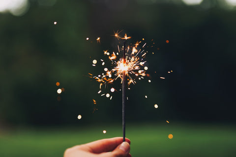 A photo of a sparkler in a backyard.