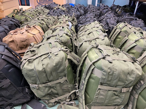 A large grouping of military grade backpacks that are being sent to Ukraine and are filled with life-saving medical supplies by Sunflower of Peace.
