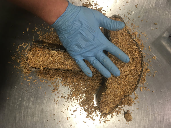 Filling the cardboard form with mycelium + hemp material