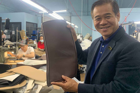 Luraco i9 Massage Chair - Tom Le - holding up part of the leather side panel ready for assembly