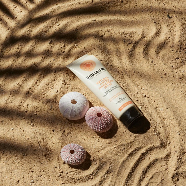 little urchin tinted sunscreen, sunscreen product on sand, urchins