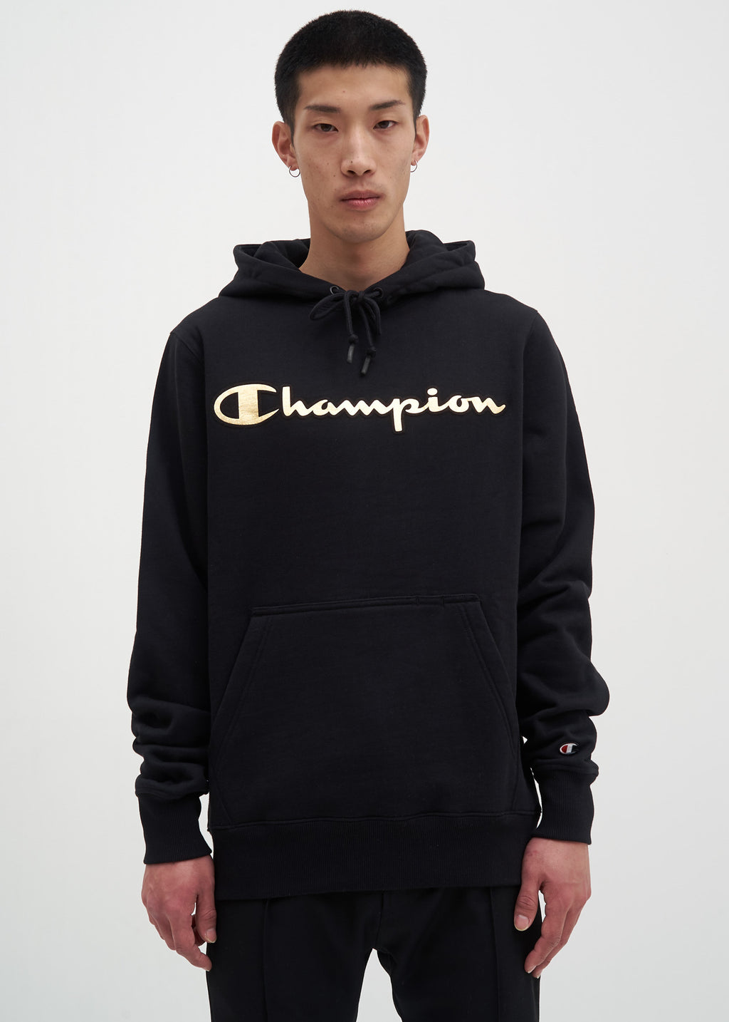 black champion hoodie with gold writing 