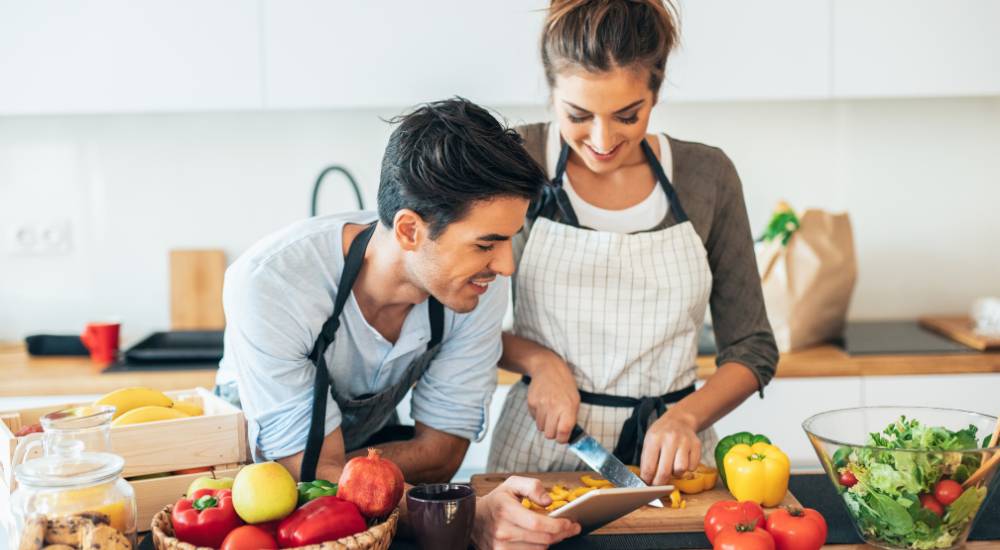 Young couple cooking together with healthy vegetables