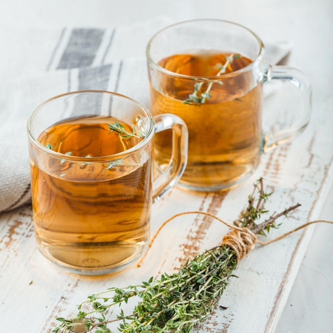 Two cups of herbal tea on a tray