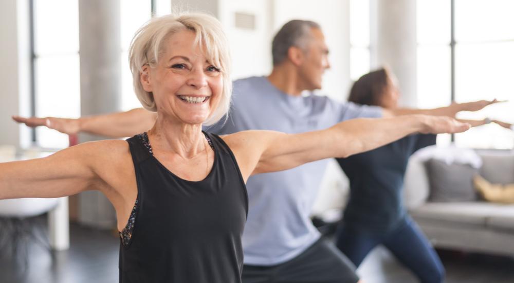 Senior couple doing balancing exercises in a studio