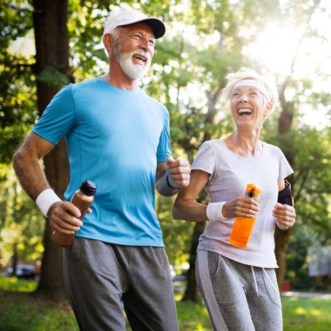 Healthy senior couple brisk walking outdoors