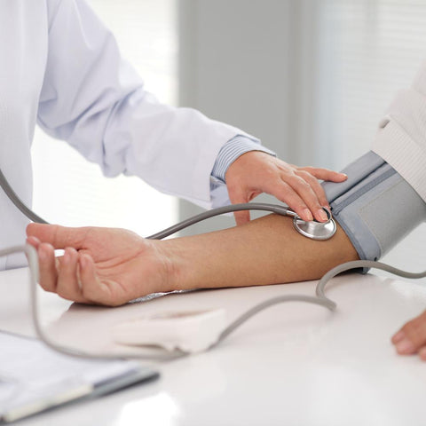 Doctor taking blood pressure from diabetic pacient