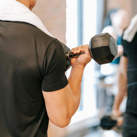 Man lifting exercising with dumbbells at the gym