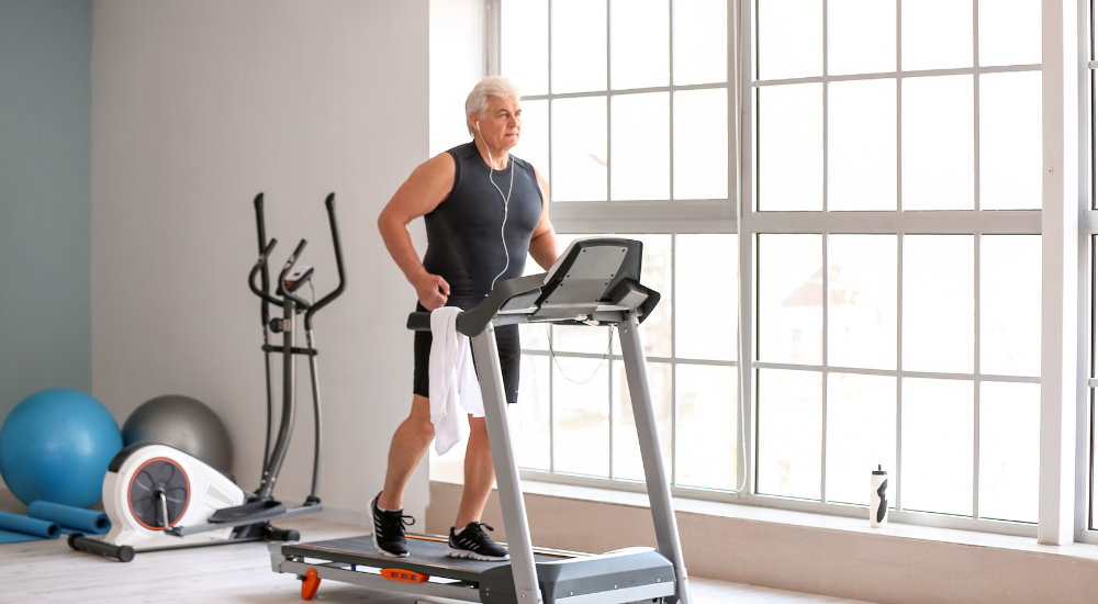 Man over 50 running on treadmill at home