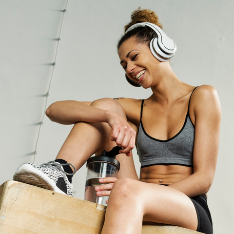 Woman happily listening to music on headphones after a workout