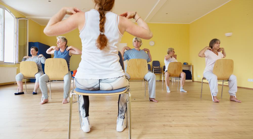 Group of older people in a chair yoga class