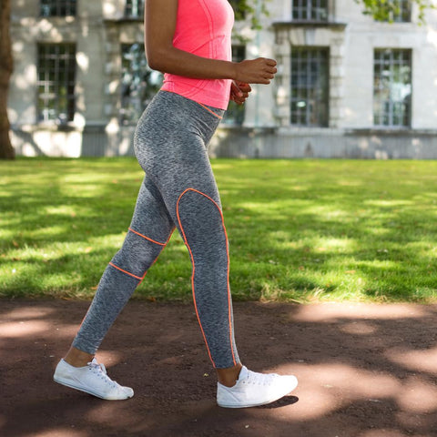 Woman brisk walking outdoors at a park