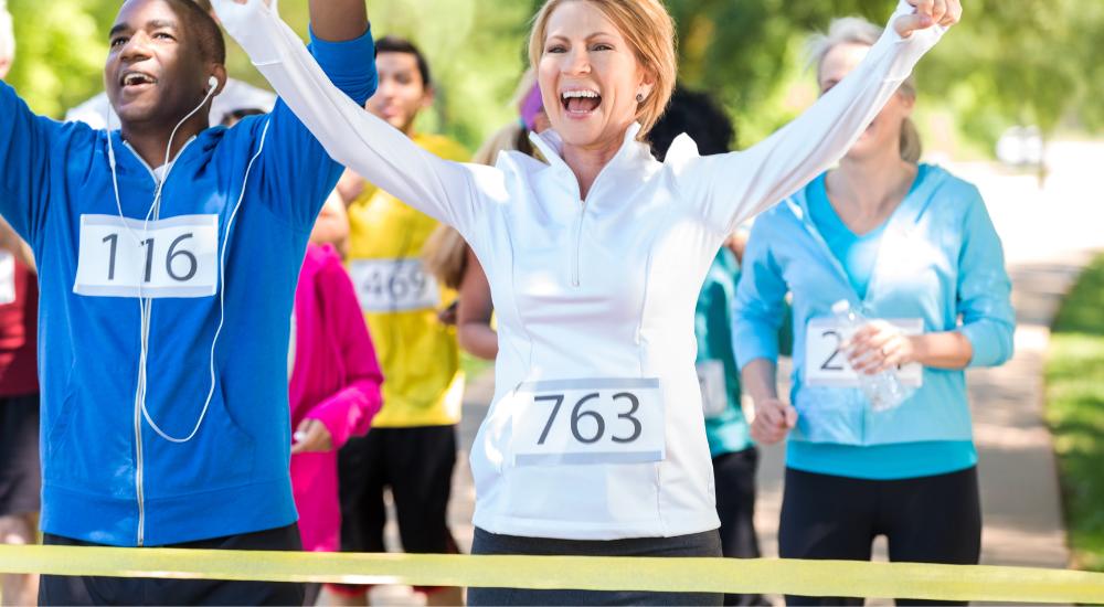 Smiling woman celebrating coming first on walking marathon