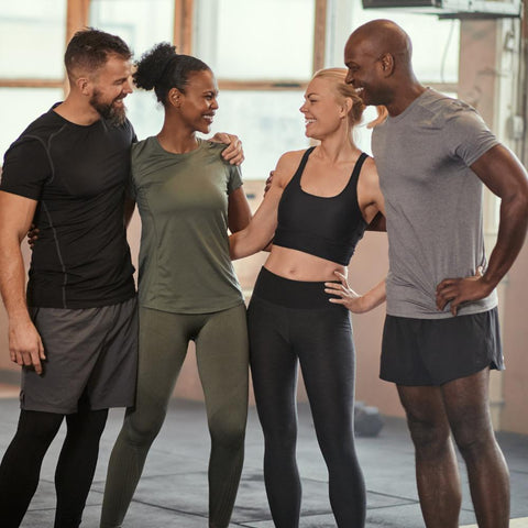 Group of young fit people hanging out at the gym