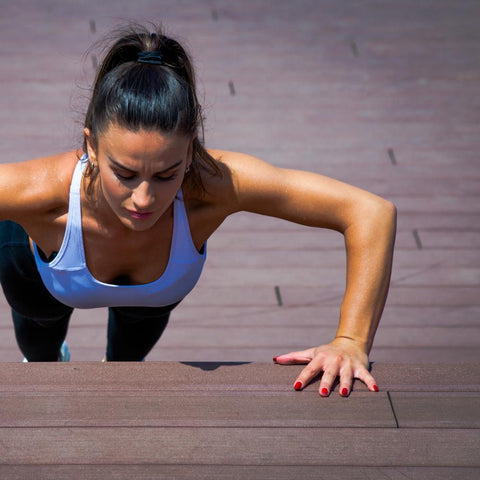 Woman doing a push-up outdoors