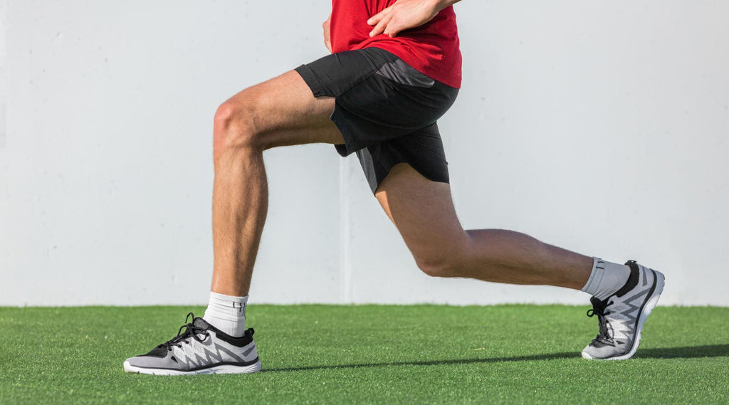 Fit athletic man stretching leg muscles before walking exercise