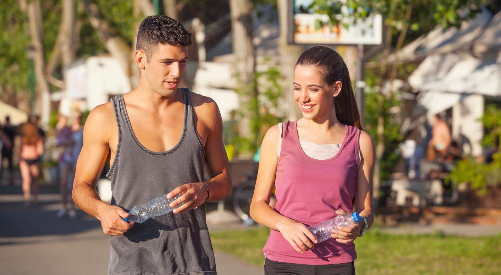 Young fit couple taking a break from walking