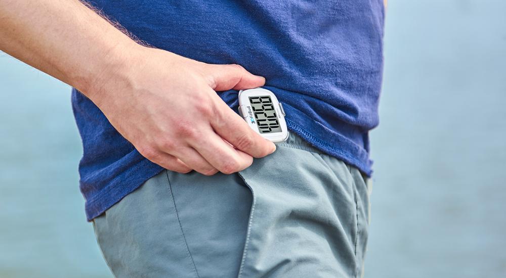 Man checking his 3DFitBud step counter for number of steps recorded after a walk