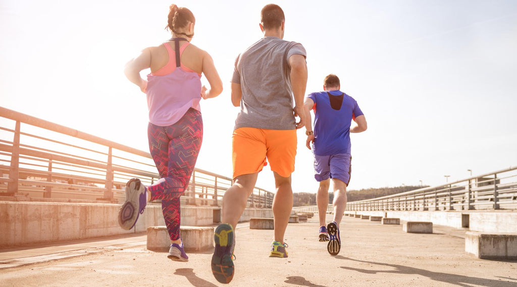 Young people jogging outdoors burning calories