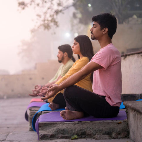 Young people practicing yoga in India