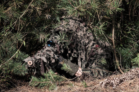 Sniper wearing a ghillie suit