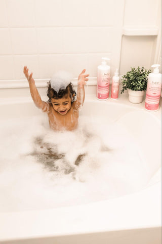 Kid having fun in a bubble bath