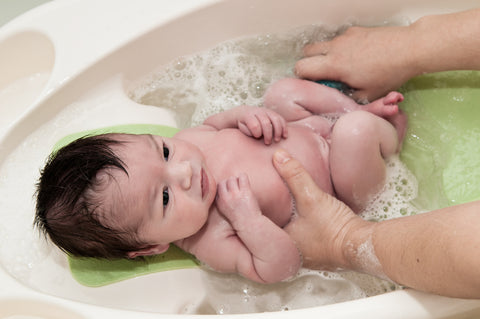 newborn in tub at bath time
