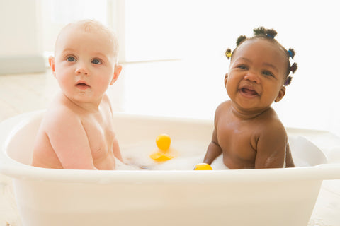 two babies talking a bubble bath
